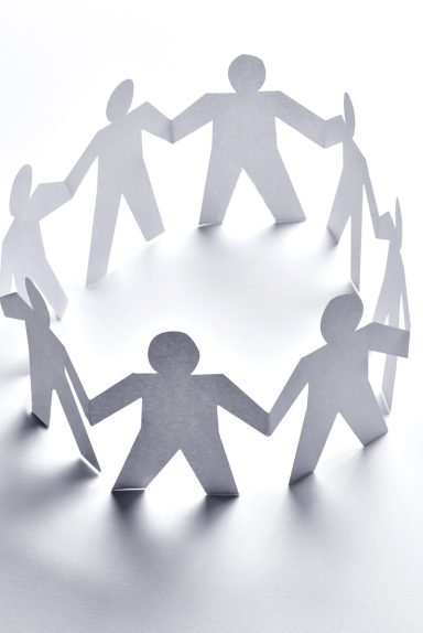 close up of paper people on white background